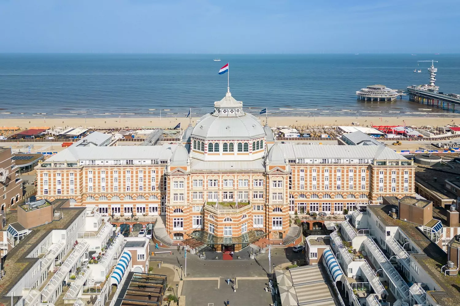 Amrath Kurhaus Scheveningen viewed from above, with the North Sea and Scheveningen Pier behind it